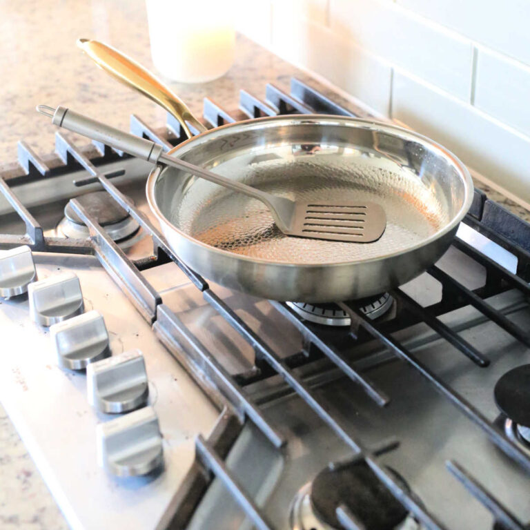 Taima Titainium cookware Nutro Pro frying pan with spatula on the stove.