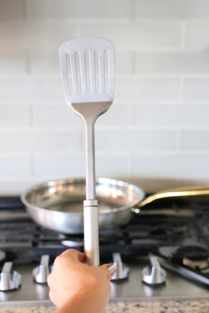 Titanium spatula held over the stove.